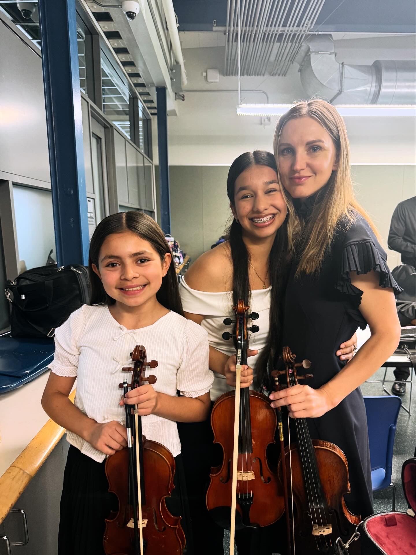 Mila with a young violin student