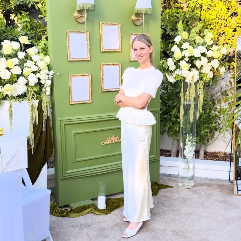 Mila by the floral ceremony entrance