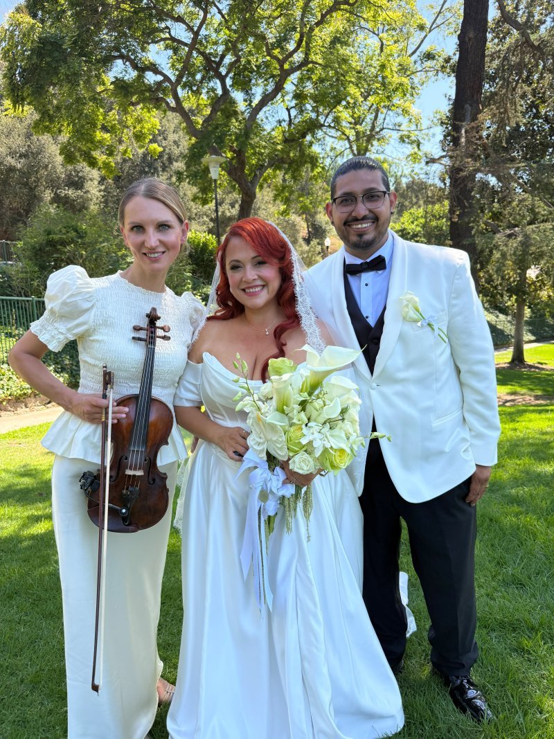Mila with the bride and groom on the lawn