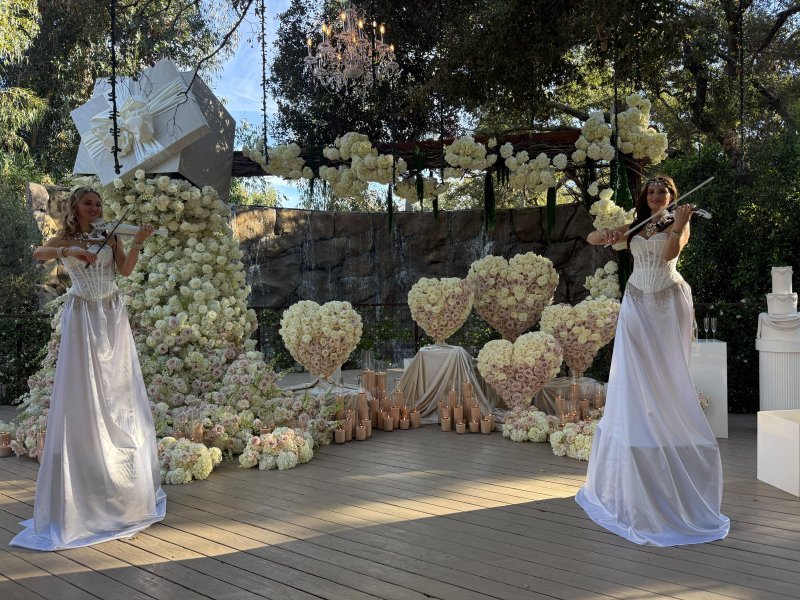 Violin duo performing at a wedding, wide view
