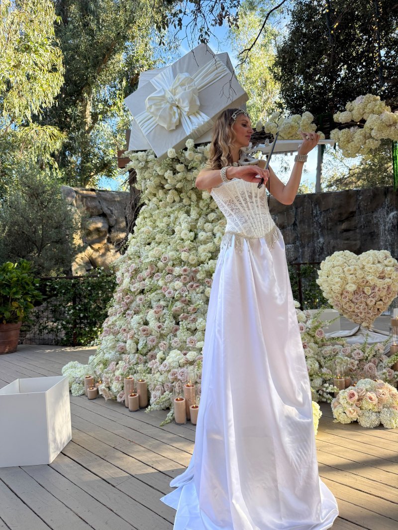 Live violin against a white floral backdrop