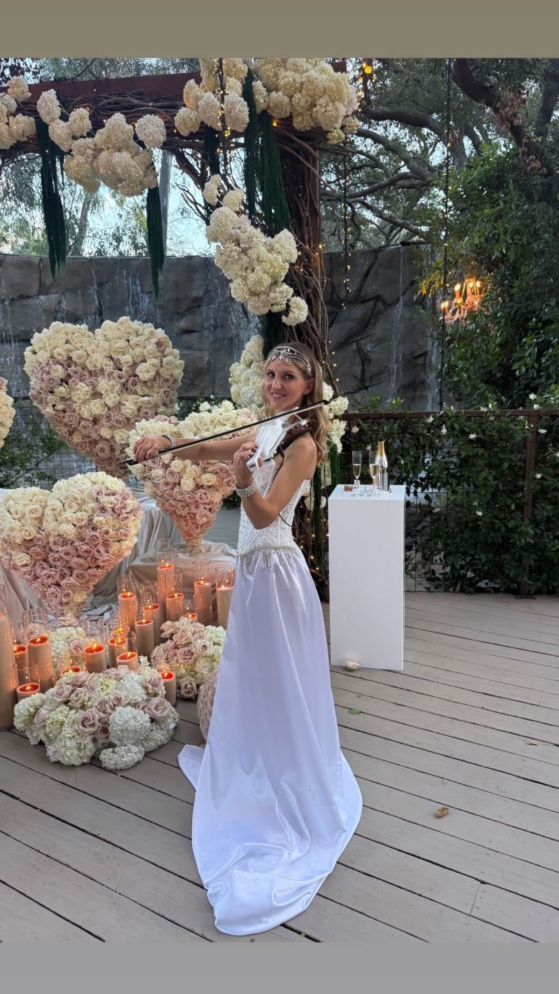 Live violin beside a floral heart display
